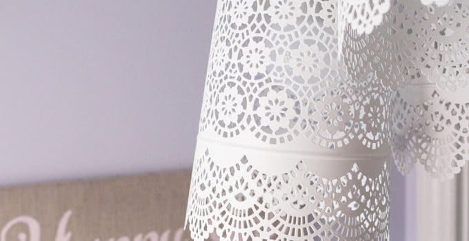 A pretty and delicate lace-like pendant chandelier made for less than $35 using three metal candle holders and a triple pendent cord set from ikea.
